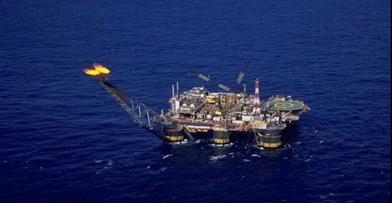 Plataforma de petróleo da Petrobras em alto-mar com queimador de gás aceso